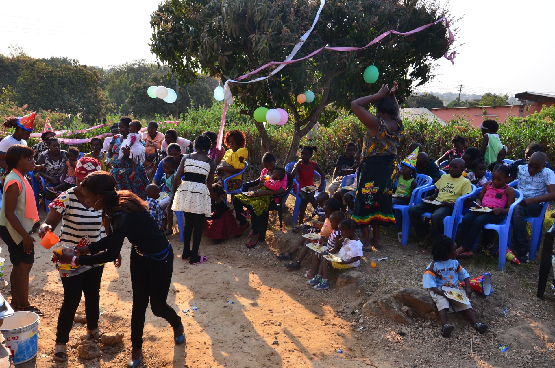 Children and families gathered outdoors at an MCF community celebration